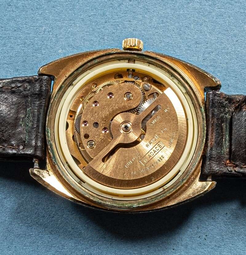 Image of rear of watch with the back removed showing one side the movement with the rotor.