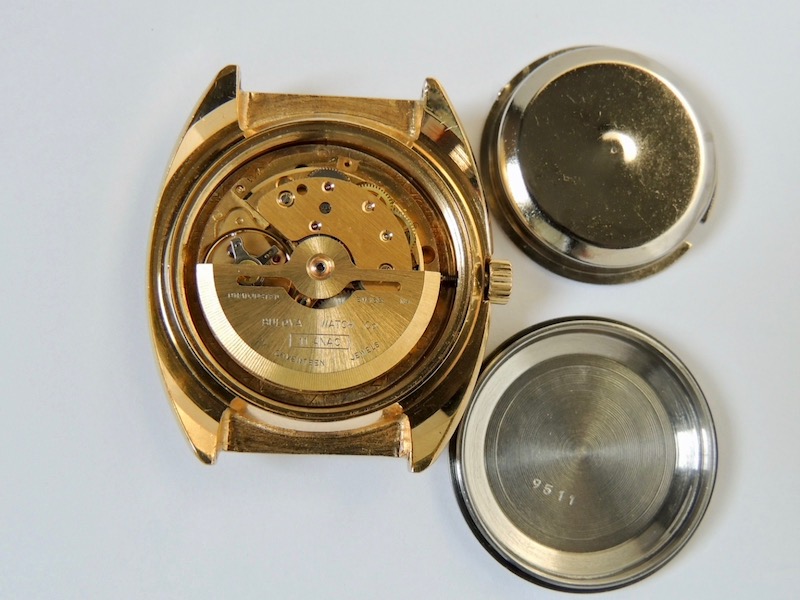 Watch back removed to show movement.