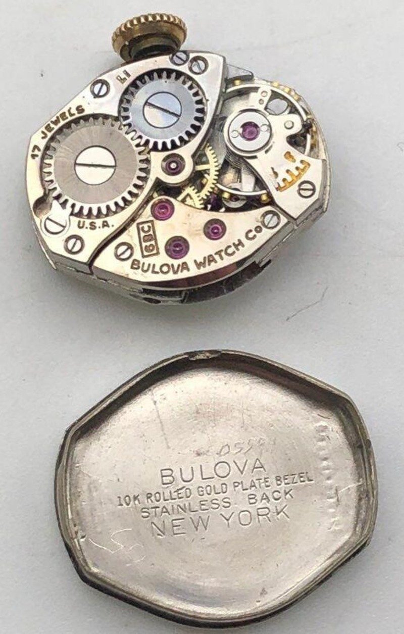 Uncased movement, watchmaker's side, with inside of caseback
