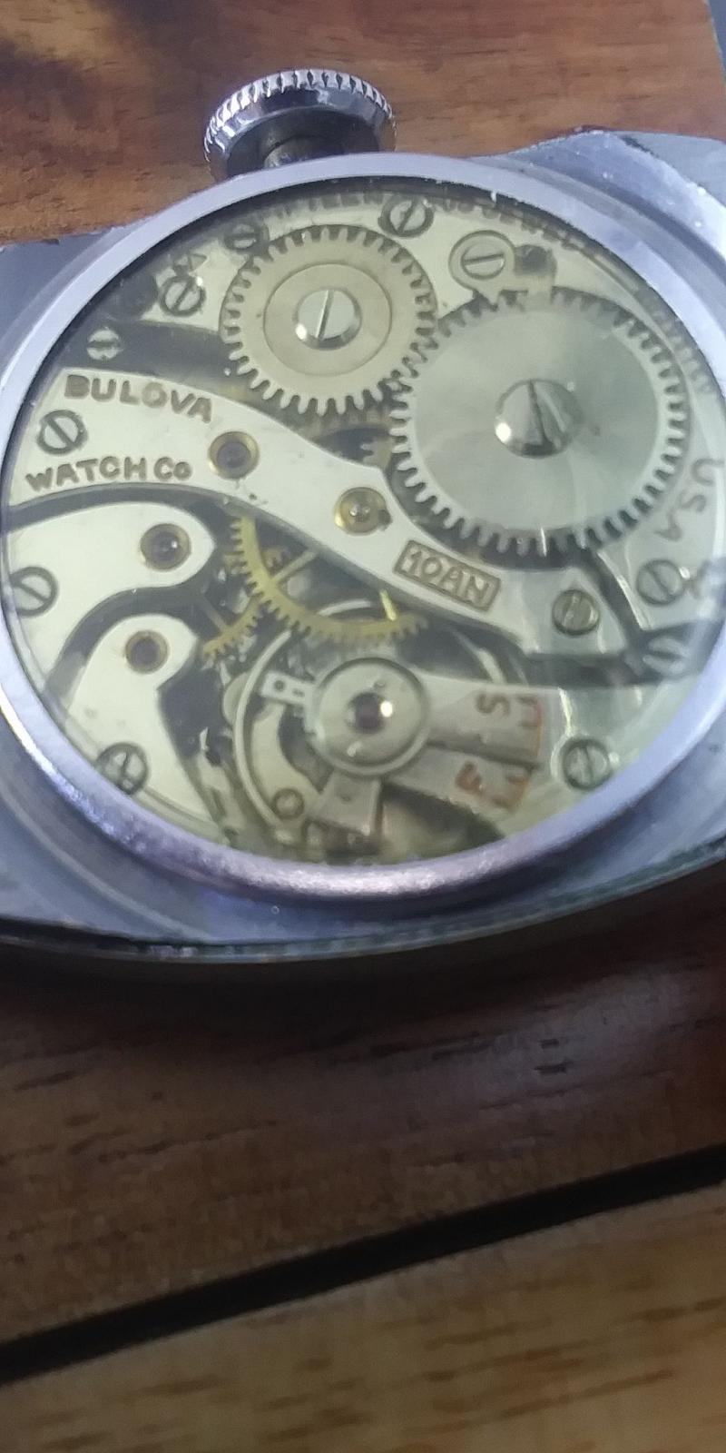 The only thing on the back of the watch just says open